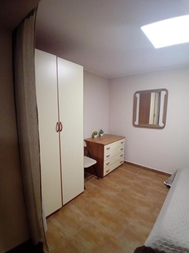 a bedroom with a bed and a dresser and a mirror at Casa Alessia in Catania