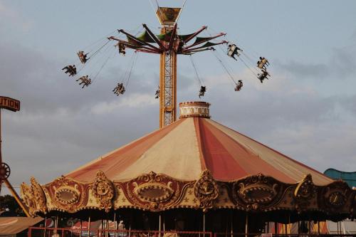 a ferris wheel with people on it at a carnival at Holiday Inn - the niu Star Sindelfingen by IHG in Sindelfingen