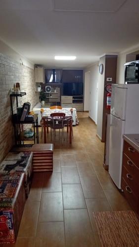 a kitchen and living room with a table and a refrigerator at Casa Alessia in Catania