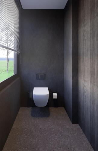 a bathroom with a white toilet in a room at The Ruler Cabin in Penginyahan