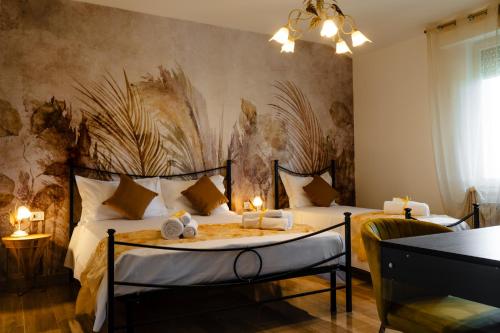 a bedroom with two beds with towels on them at Villa Yucca - B&B and Glamping in Torano Nuovo