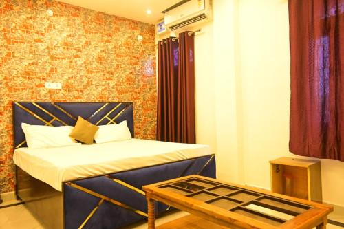 a small room with a bed and a table at Bajrangbali Guest House in Ayodhya