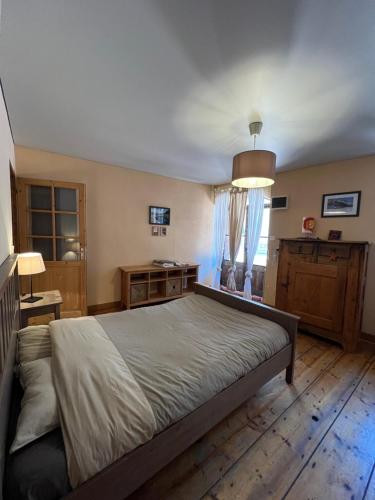 a bedroom with a large bed in a room at La compagnie du bourg in Le Châtelard