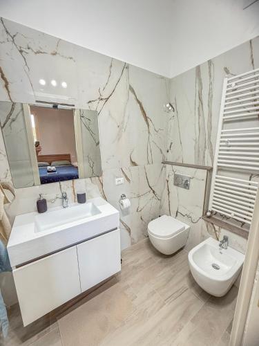 a white bathroom with a sink and a toilet at Villa Miky - Via Francigena Altopascio in Orentano