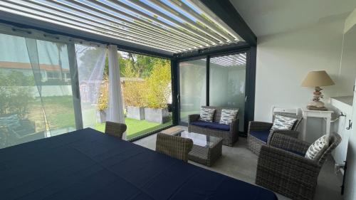 a dining room with a table and chairs and a large window at Résidence San Paolisa in Hyères