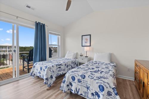 a bedroom with two beds and a balcony at Chipps Ahoy in Oak Island