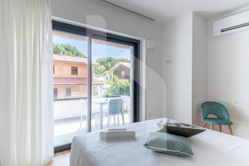 Ένα ή περισσότερα κρεβάτια σε δωμάτιο στο Homiday - Residenza Pinetina