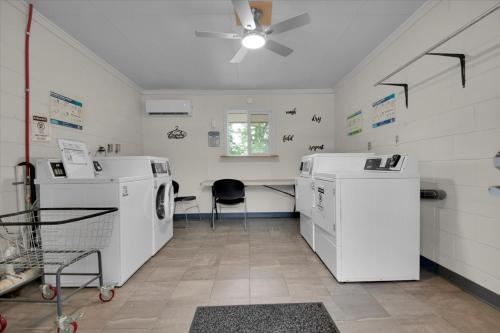 a laundry room with a washer and dryer at Charming Cabin with Parking in Pigeon Forge