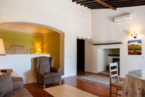 a living room with a chair and a fireplace at Horta da Moura by WOT Signature in Monsaraz