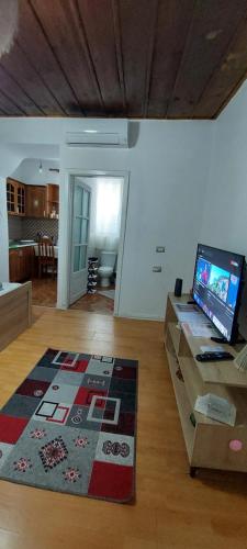 a living room with a flat screen tv on a table at Guest House Flowers in Berat