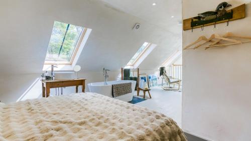 a bedroom with a large bed and a sink at Bwthyn Ysgubor in Conwy