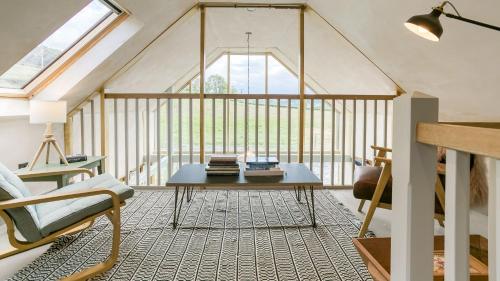 a living room with a table and a window at Bwthyn Ysgubor in Conwy