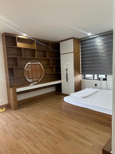 a large room with a bed and a refrigerator at Bong Mai Thai Hoa Hotel in Làng Dương