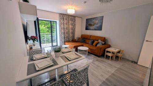 a living room with a table and a couch at JASMIN HOME Apartments in Vítkovice