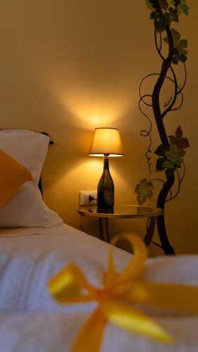 a bedroom with a bed with a lamp on a table at Villa Yucca - B&B and Glamping in Torano Nuovo
