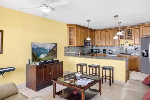 a living room with a kitchen with a table at Cheerful Seascape Condo Happy Haven at Rainbow Beach Club in Cupe Coy