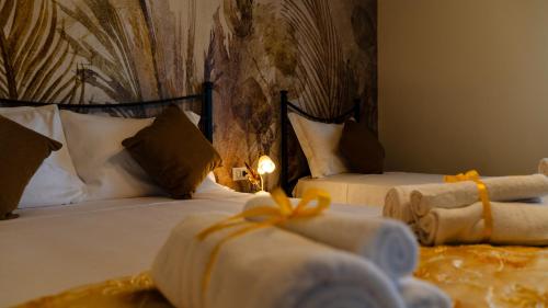 two beds in a hotel room with a candle on them at Villa Yucca - B&B and Glamping in Torano Nuovo