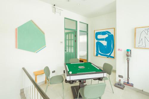 a room with a ping pong table and chairs at 小樹林 Little Mori 包棟民宿 in Tainan