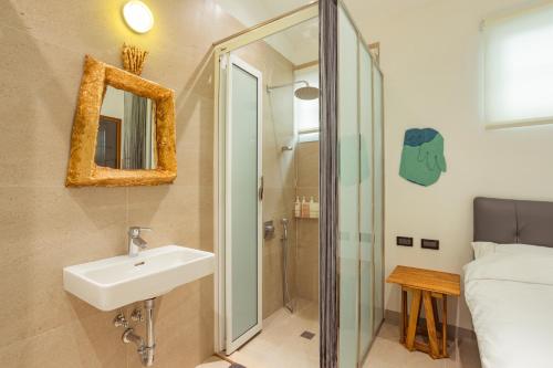 a bathroom with a sink and a shower at 小樹林 Little Mori 包棟民宿 in Tainan