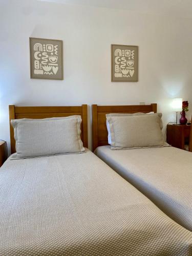 two beds sitting next to each other in a room at Casas Campo Cimo da Quinta in Miranda do Douro