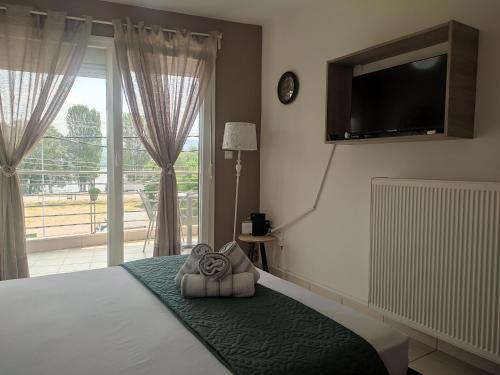 a bedroom with a bed with a tv on the wall at Filareti studios in Kastoria