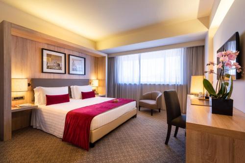a hotel room with a bed and a desk at A.Roma Lifestyle Hotel in Rome