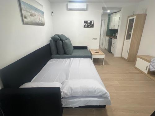 a bedroom with a large bed and a chair at Can Paquito Fuerteventura in Corralejo