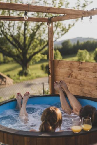 a group of people laying in a hot tub at Sowie Chatki - domki z widokiem na Góry Sowie in Sokolec