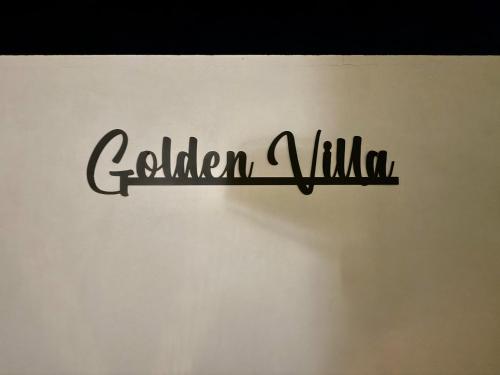 a sign that reads garden village on a wall at GOLDEN VILLA by Stay in Alentejo in Vila Nova de Milfontes