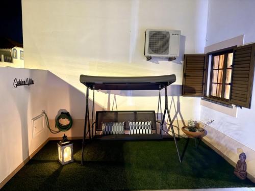 a black table in a room with a window at GOLDEN VILLA by Stay in Alentejo in Vila Nova de Milfontes