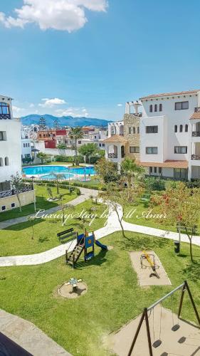 a park with a playground in a city at LuxuryStay by Al Amir in Martil