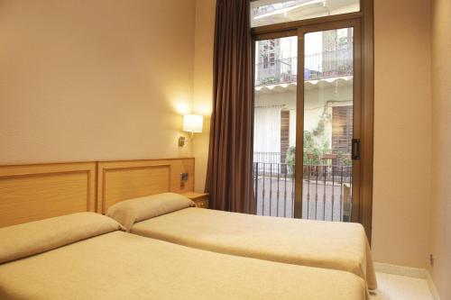 Postel nebo postele na pokoji v ubytování Hostal Nuevo Colon
