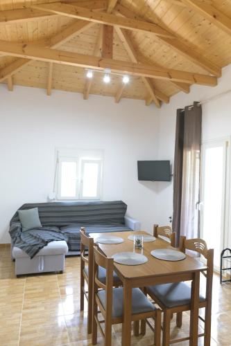 a living room with a table and a couch at Babis Apartment Agios Nikitas in Agios Nikitas