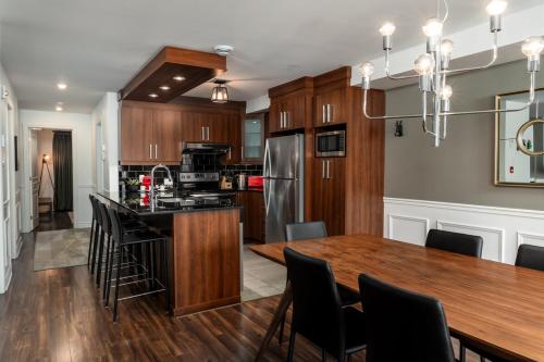 a kitchen and dining room with a wooden table at Chic condo at the foot of the slopes of Saint-Sauveur in Saint-Sauveur-des-Monts