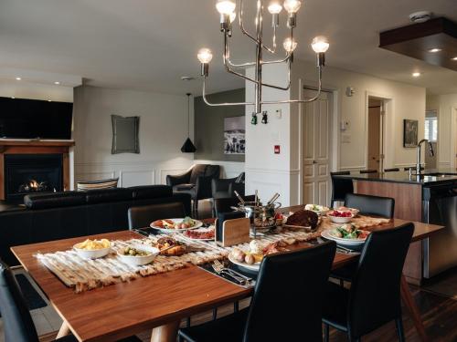 a dining room with a table with food on it at Chic condo at the foot of the slopes of Saint-Sauveur in Saint-Sauveur-des-Monts