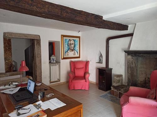 a living room with a desk and a red chair at Zen and Breakfast in Veiano