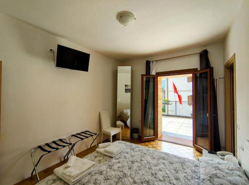 a bedroom with a bed and a sliding glass door at Hotel Da Marco in Vigo di Cadore