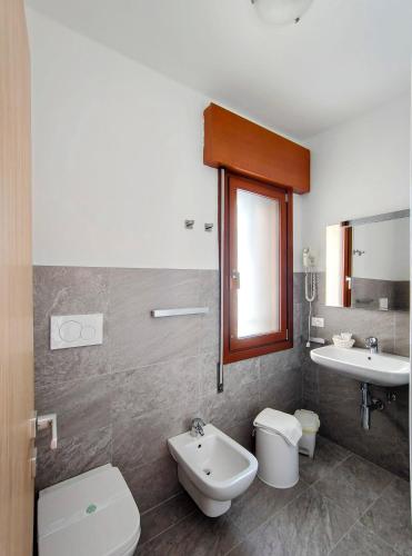 a bathroom with a toilet and a sink at Hotel Da Marco in Vigo di Cadore
