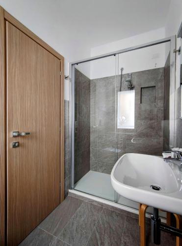 a bathroom with a tub and a sink and a shower at Hotel Da Marco in Vigo di Cadore