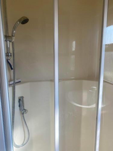 a shower with a shower head in a bathroom at Pet Friendly Location Close To Beach in Ingoldmells