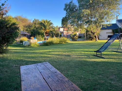 a playground with a slide and a table in a yard at Tiny house in Bahía Blanca