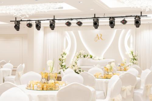 a white wedding with white chairs and tables and flowers at فندق واحة روز in Jeddah