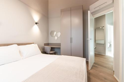 a bedroom with a white bed and a closet at Villa Sabrina in Colico