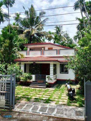 a house with a motorcycle parked in front of it at 'Ananda' Homestay in Murud in Dande