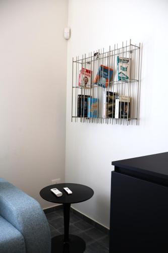 a room with a couch and a table and a shelf at IL CARRUBO La dimora in Monopoli