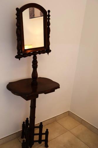 a mirror on a table in a room at IL CARRUBO La dimora in Monopoli