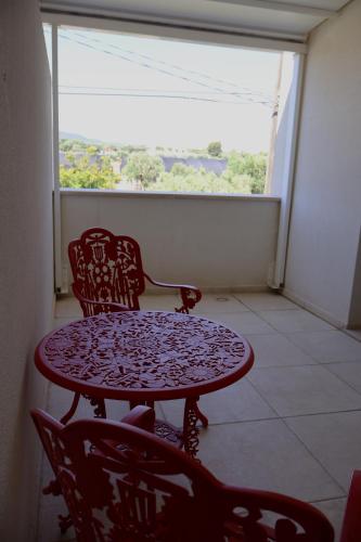 a table and chairs in a room with a window at IL CARRUBO La dimora in Monopoli