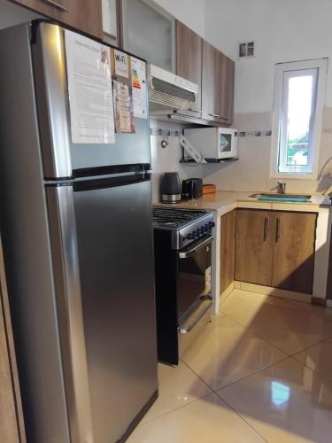 a kitchen with a stainless steel refrigerator and a stove at Chalet Liwen in San Martín de los Andes