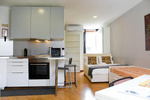 a small apartment with a kitchen and a bed at São Pedro City Flat in Vila Real