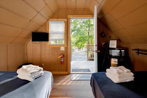 a room with two beds and a door to a yard at Cozy Cabin Near Dollywood in Pigeon Forge